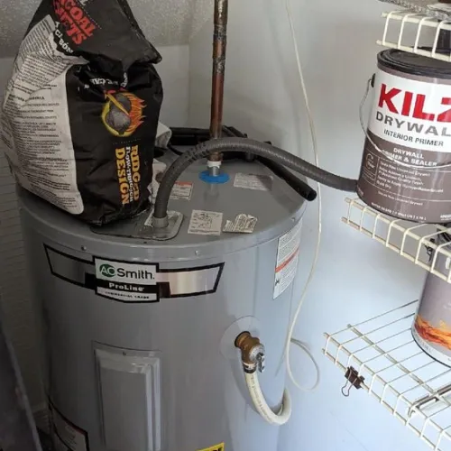 A bag of kilz drywall sitting on top of a water heater | The Duke Of Plumbing