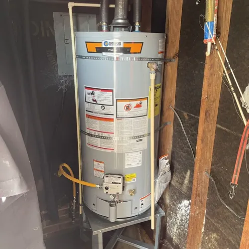 A water heater is sitting on a table in a basement | The Duke Of Plumbing