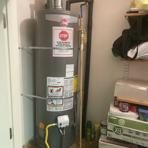 A gray water heater with a stop sign on it | The Duke Of Plumbing
