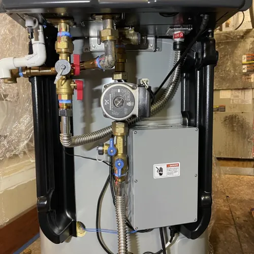 The inside of a boiler with a warning label on it | The Duke Of Plumbing