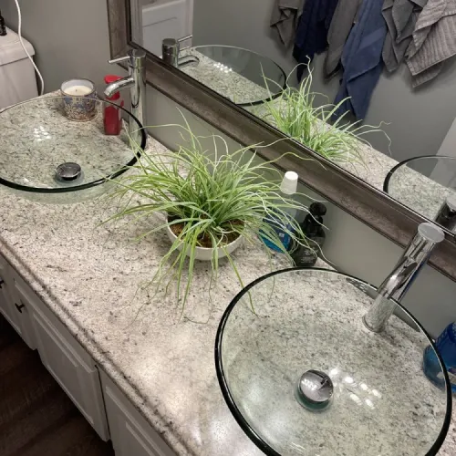 A bathroom with two sinks and a mirror | The Duke Of Plumbing