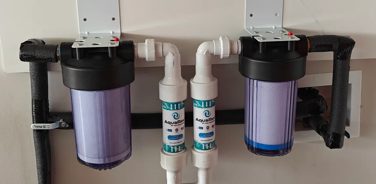 A couple of water filters hanging on a wall | The Duke Of Plumbing