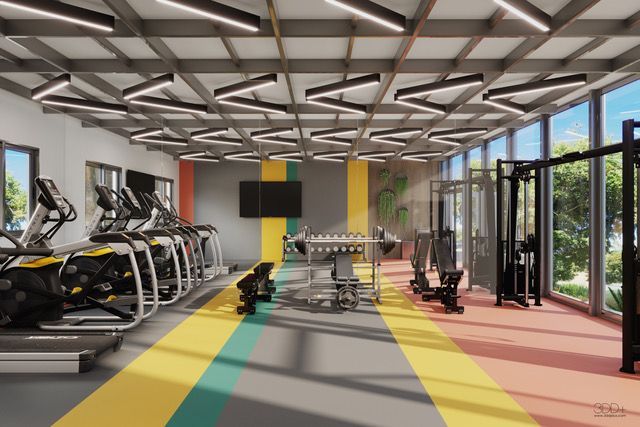 Modern gym with treadmills, bikes, weights, and bright colored floor lanes by large windows