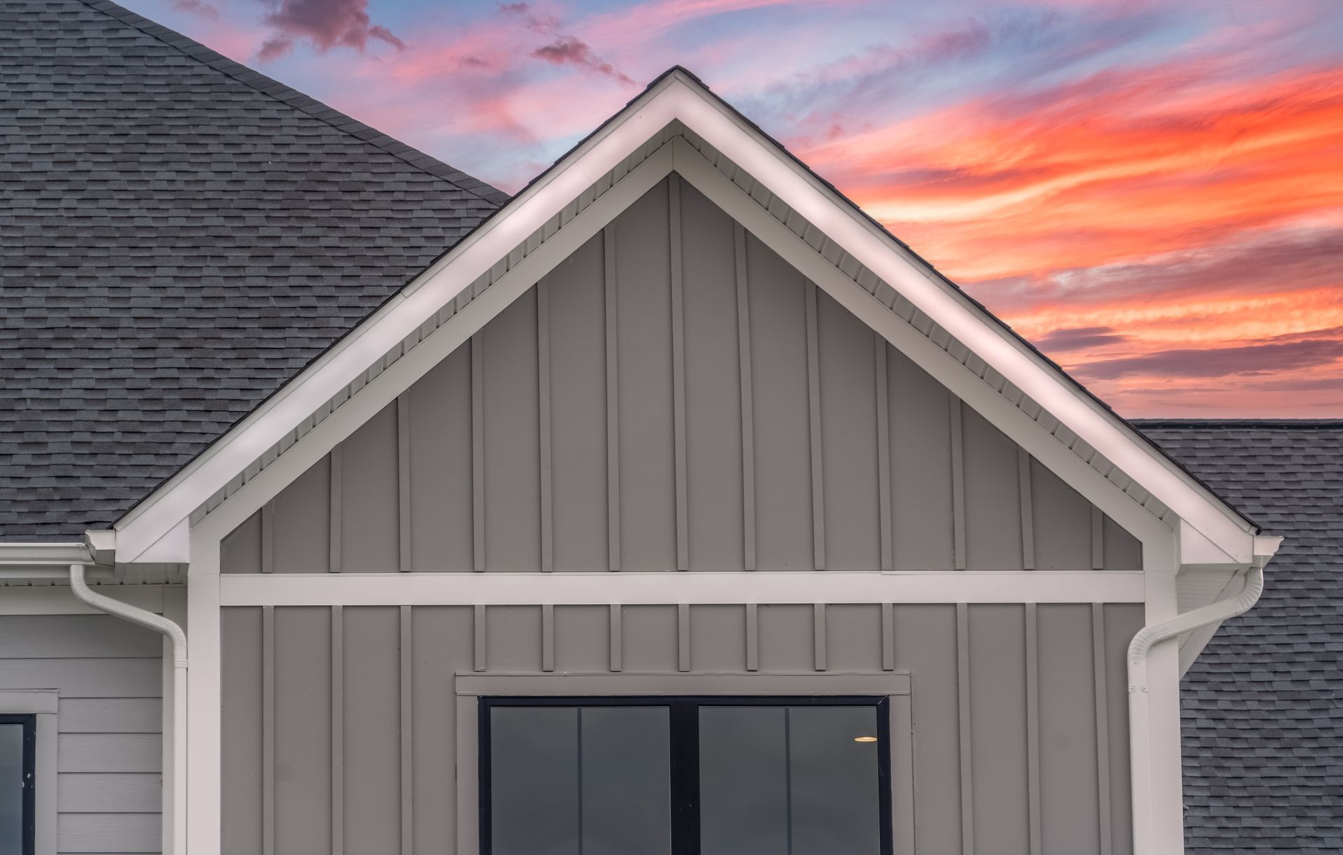 the roof of a house with a sunset in the background .