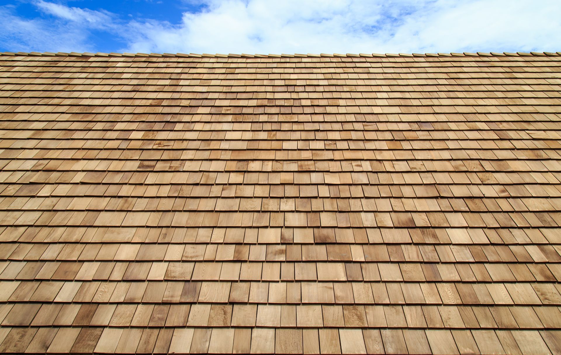 a wooden roof with a blue sky in the background