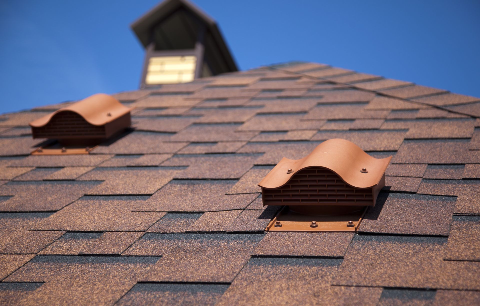 a close up of a roof with two vents on it