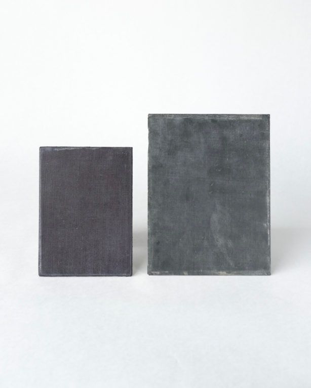 Two gray rectangular blocks, one smaller and one larger, on a white background