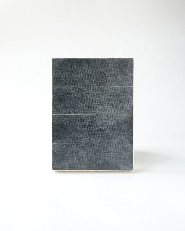 Dark gray rectangular object with three horizontal bands on a white background