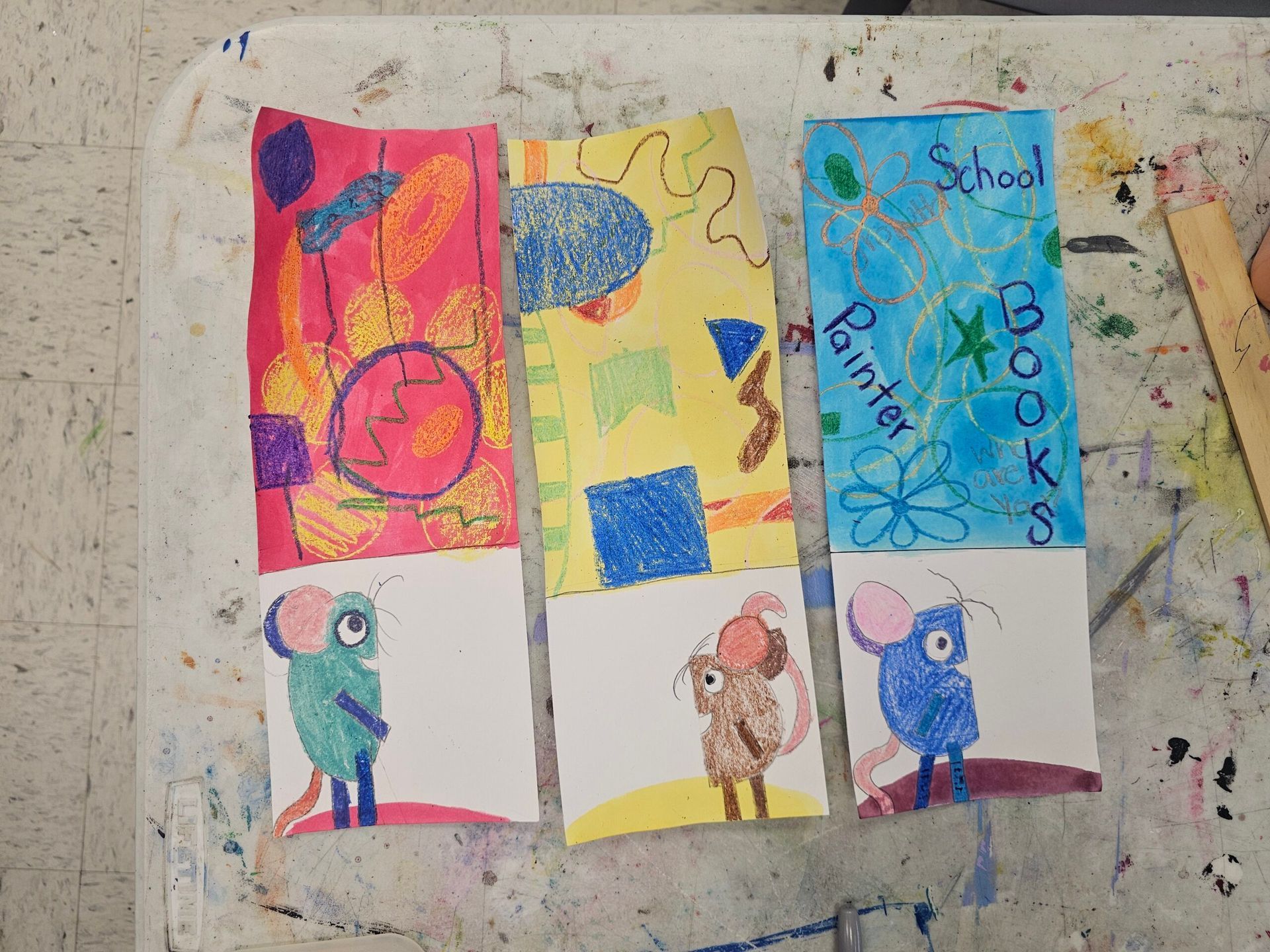 Six colorful child-made drawings pinned on a wall, with blue, pink, yellow, and animal figures.