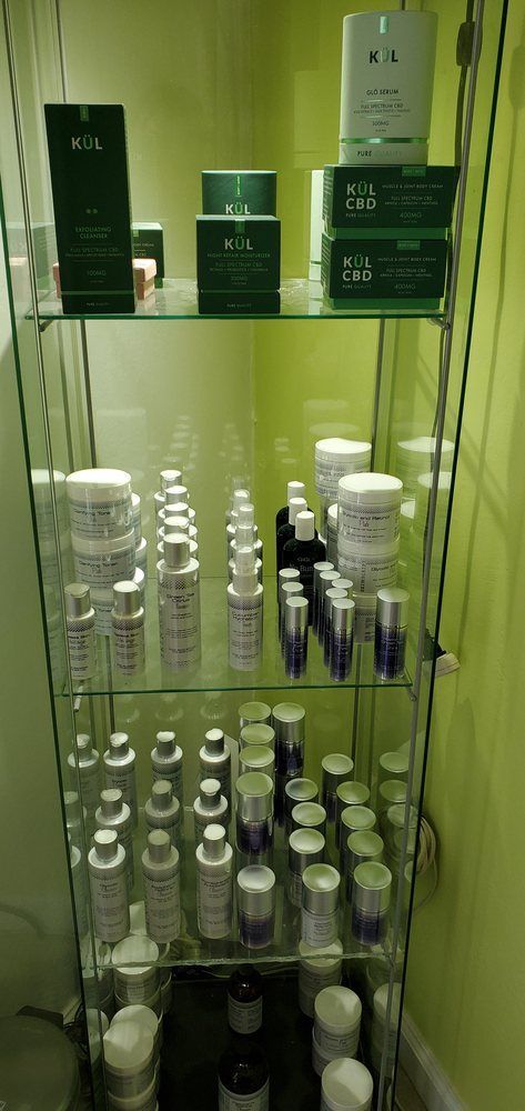 A shelf filled with lots of bottles and jars of cosmetics.