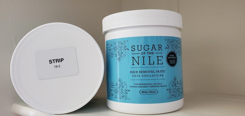 A jar of sugar in the nile is sitting on a table.
