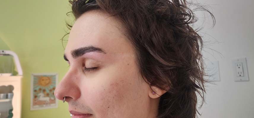 A close up of a person 's face with their eyes closed.