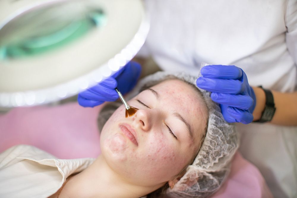 A woman is getting a facial treatment at a beauty salon.