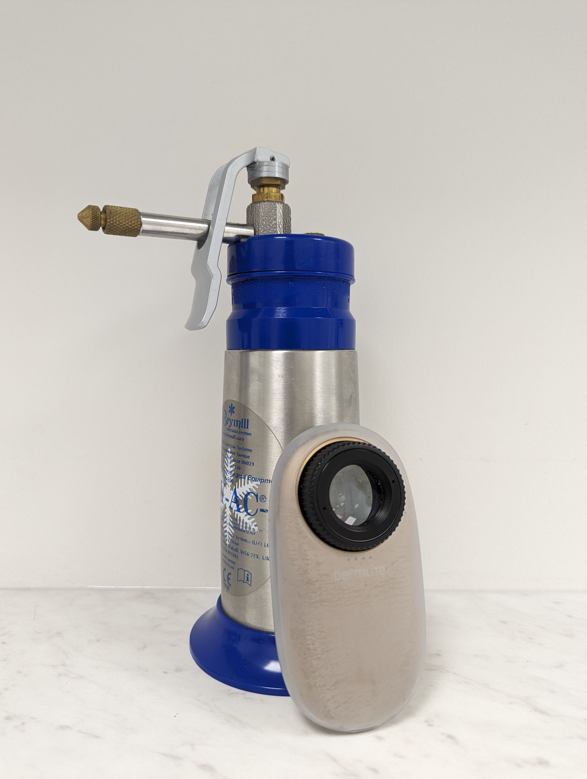 A bottle of liquid is sitting on a table next to a magnifying glass.