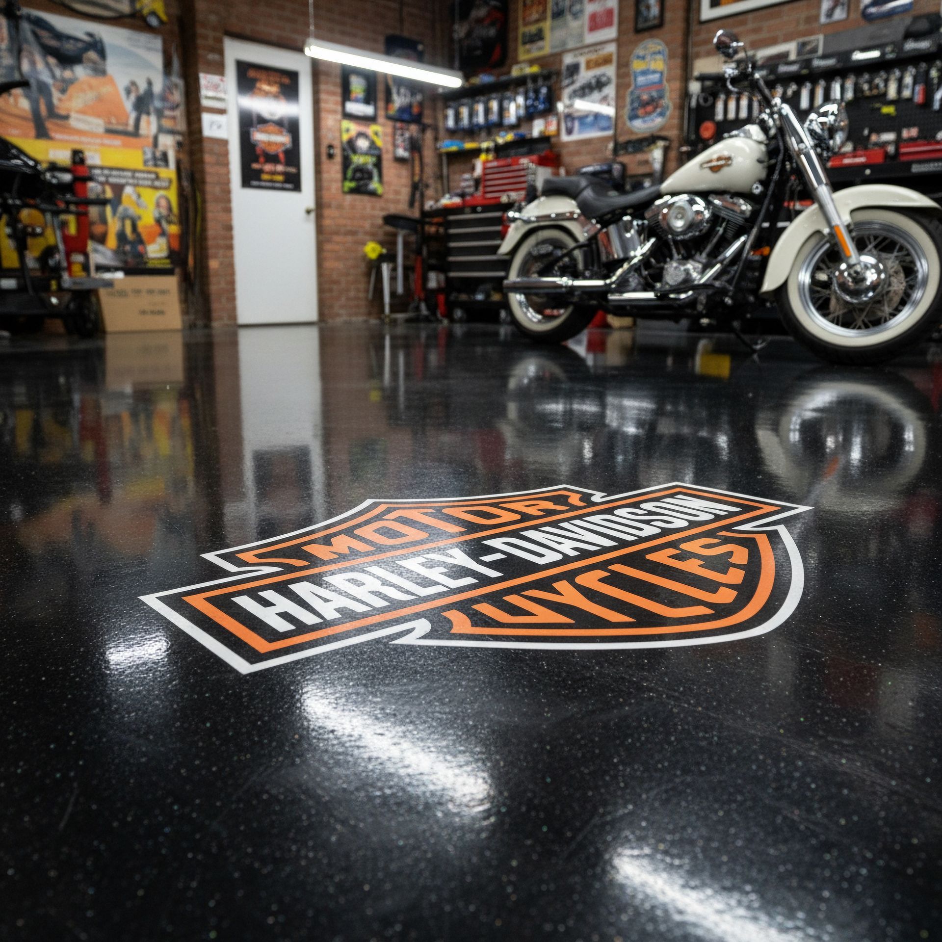 Harley-Davidson logo on a glossy garage floor with motorcycles and posters in the background