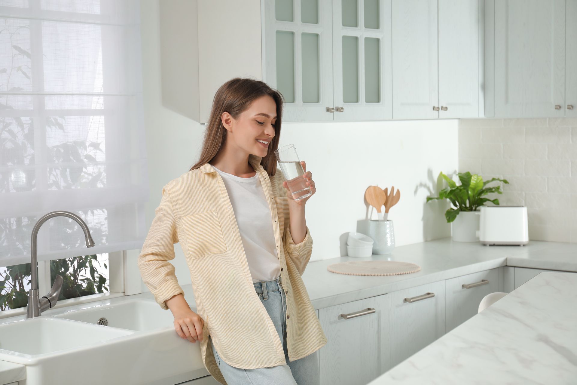 Women drinking water from Water Filtration Systems in Wakefield, MA