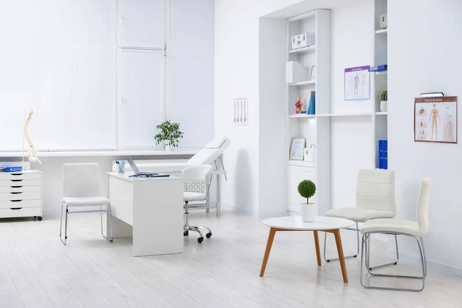 Bright white modern office with desk, chairs, shelves, and a small table in a minimalist room