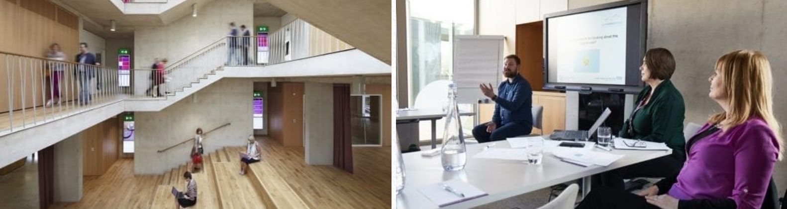 A building interior with stairs and people. Meeting in conference room with screen.