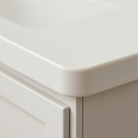 Close-up of a white cabinet corner with a rounded countertop edge