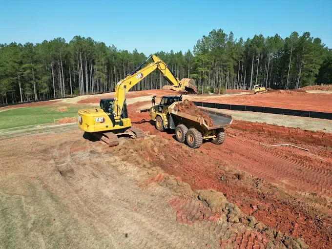 Excavator loading an articulated dump truck