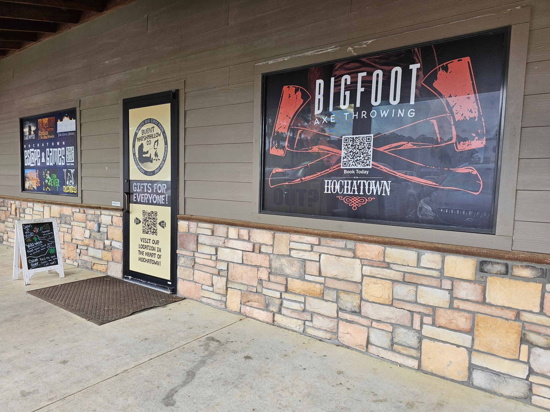 Storefront with Bigfoot Brewery sign, stone facade, glass door, and covered walkway