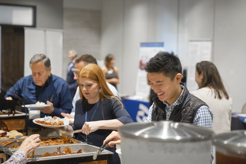 A group of people are eating food at a buffet.