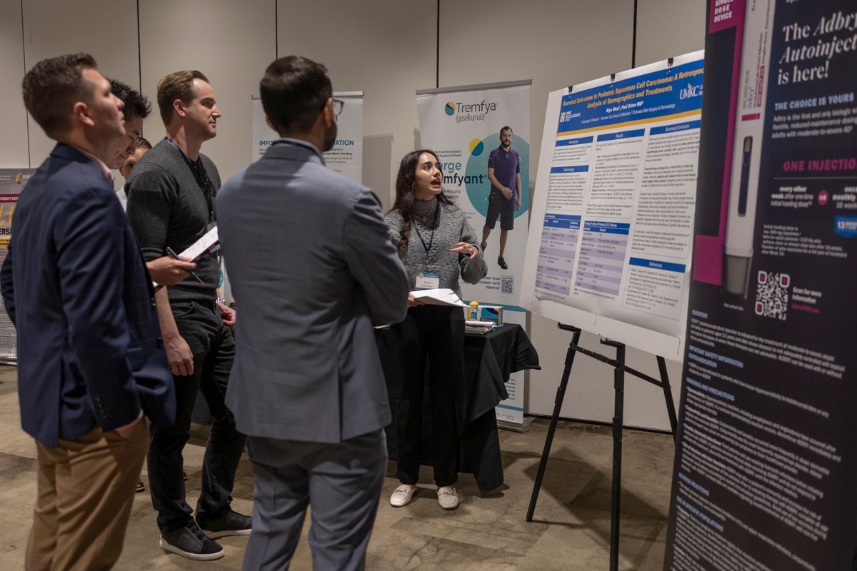 Poster presenter speaking with attendee at 2024 KSDDS Annual Conference