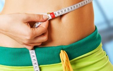 Woman Measuring Her Waist — Portage, MI — Cornerstone Chiropractic Center