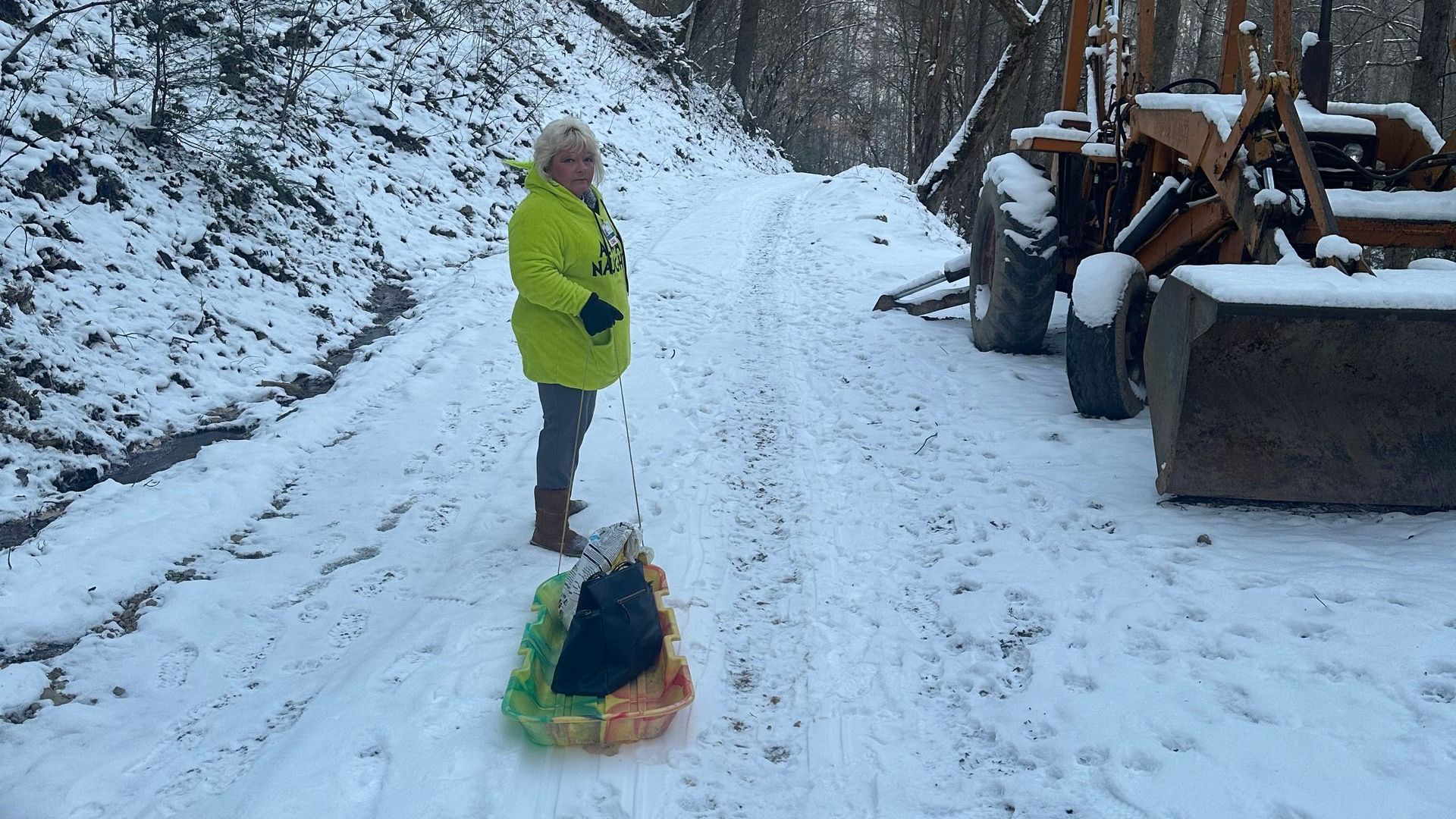 Patty May walking through the snow with supplies for hospice patients