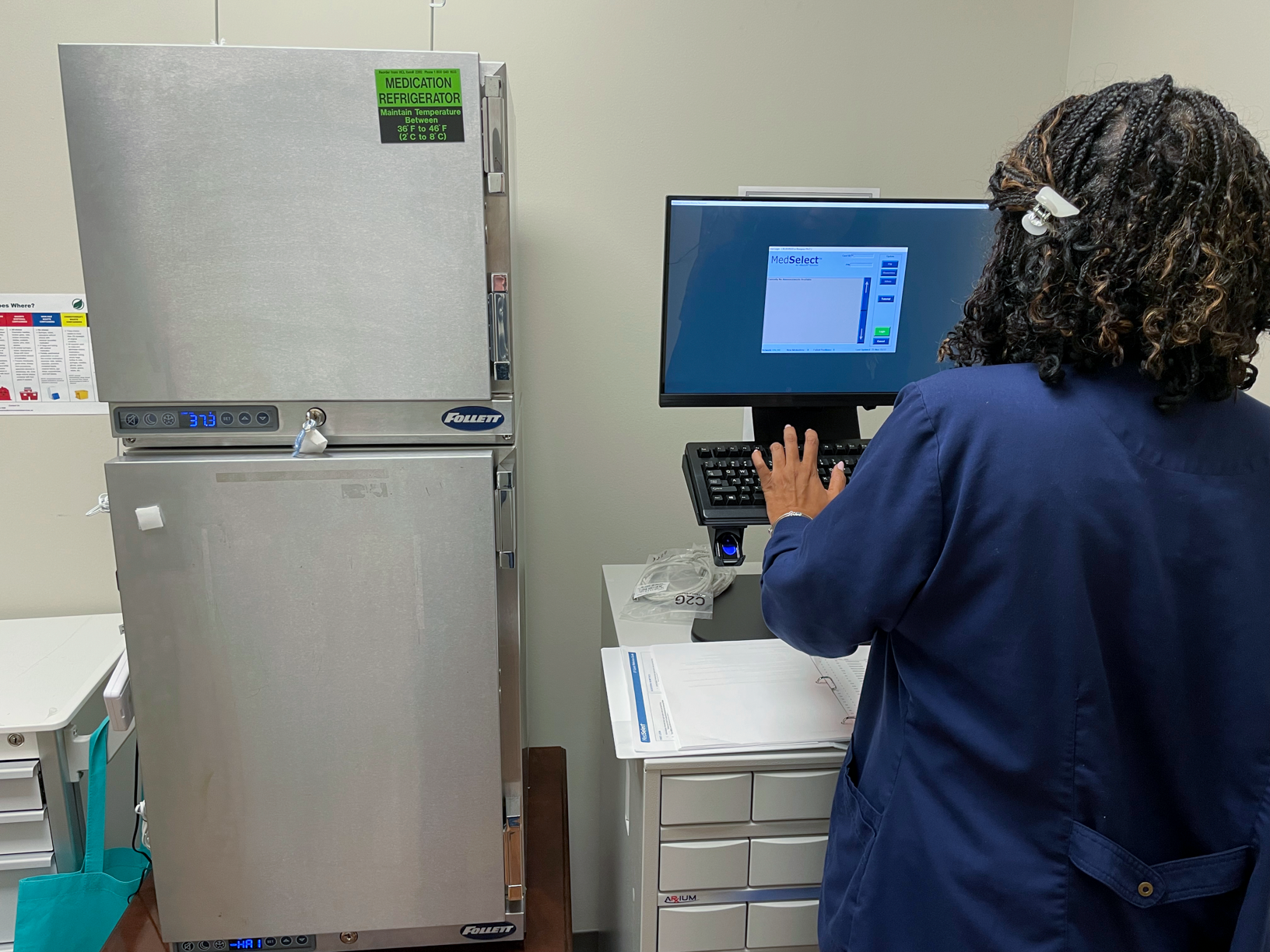 PACE pharmacy team member uses a computer workstation in the patient care area of the Bluegrass PACE Center.
