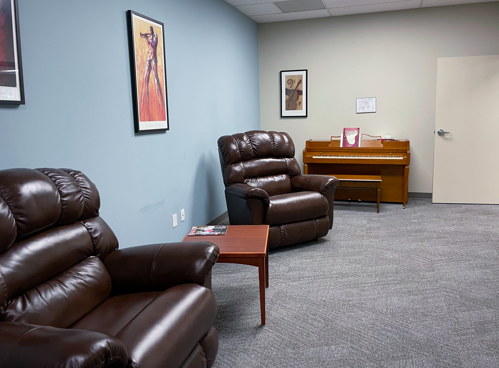 PACE Center lobby with comfortable chairs for participants and a piano in a Quiet Room.
