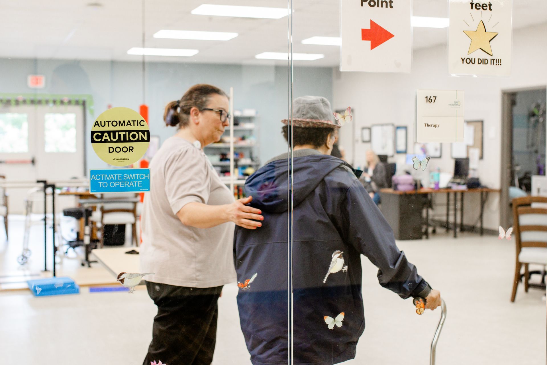 PACE worker assists a participant as they enter the PACE therapy gym.
