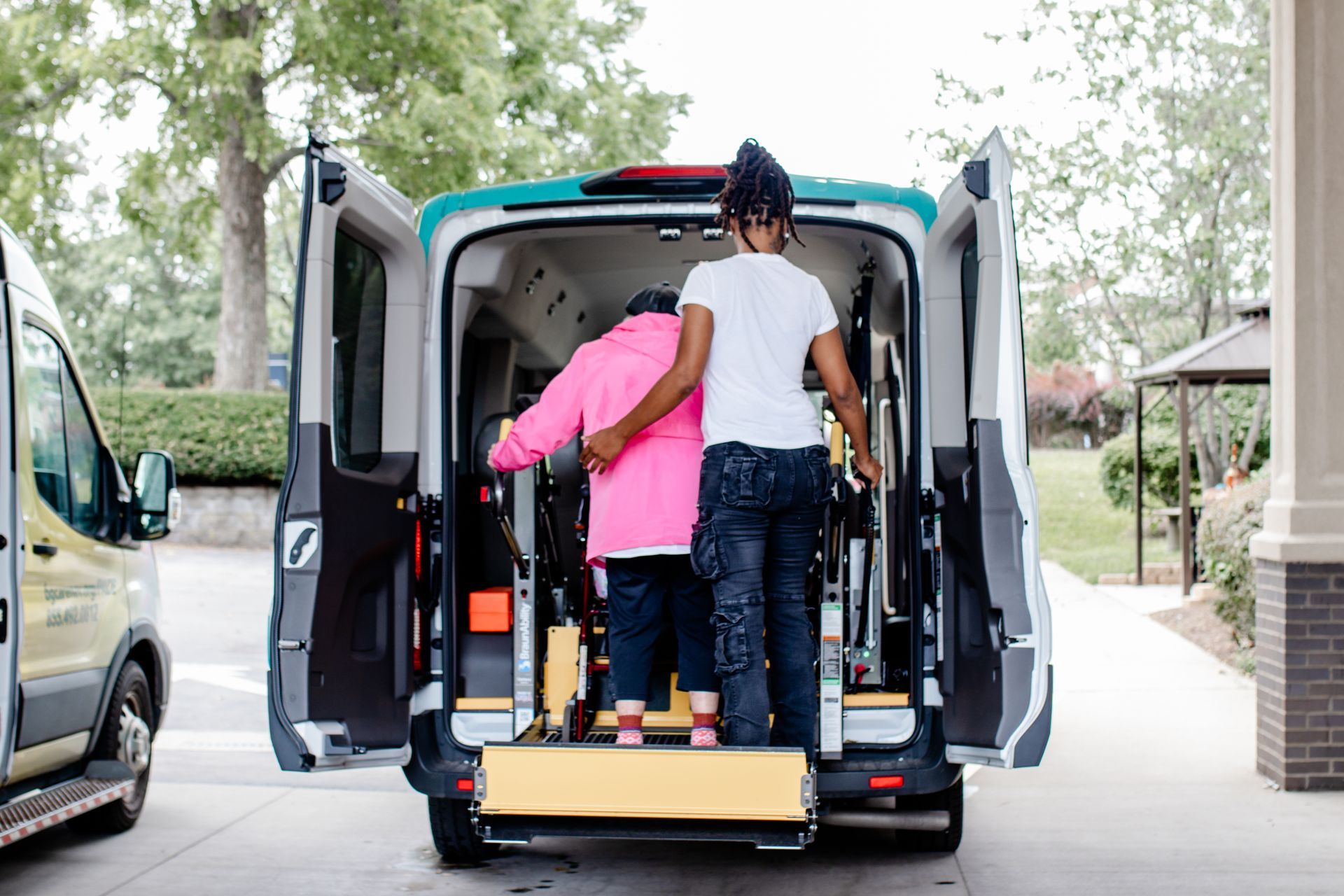 Bluegrass PACE Care PACE Center transportation driver assisting participant get into van