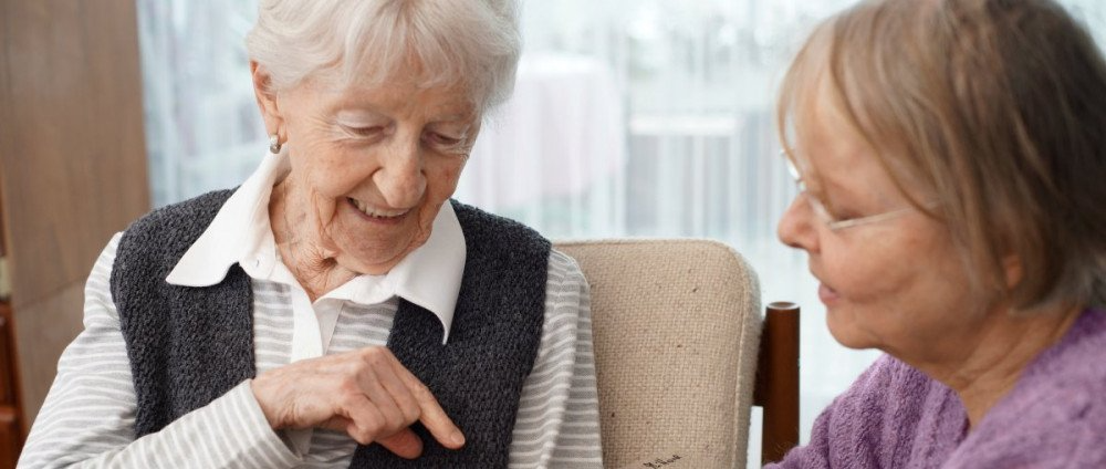 Volunteer sitting with elderly patient