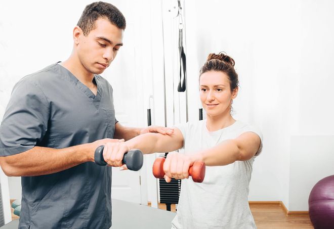 Physiotherapist-working-with-male-patient-in-clinic