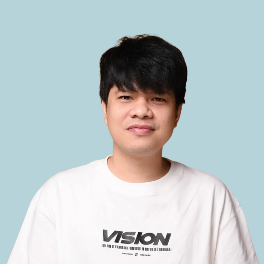 Man with black hair wearing a white t-shirt with 