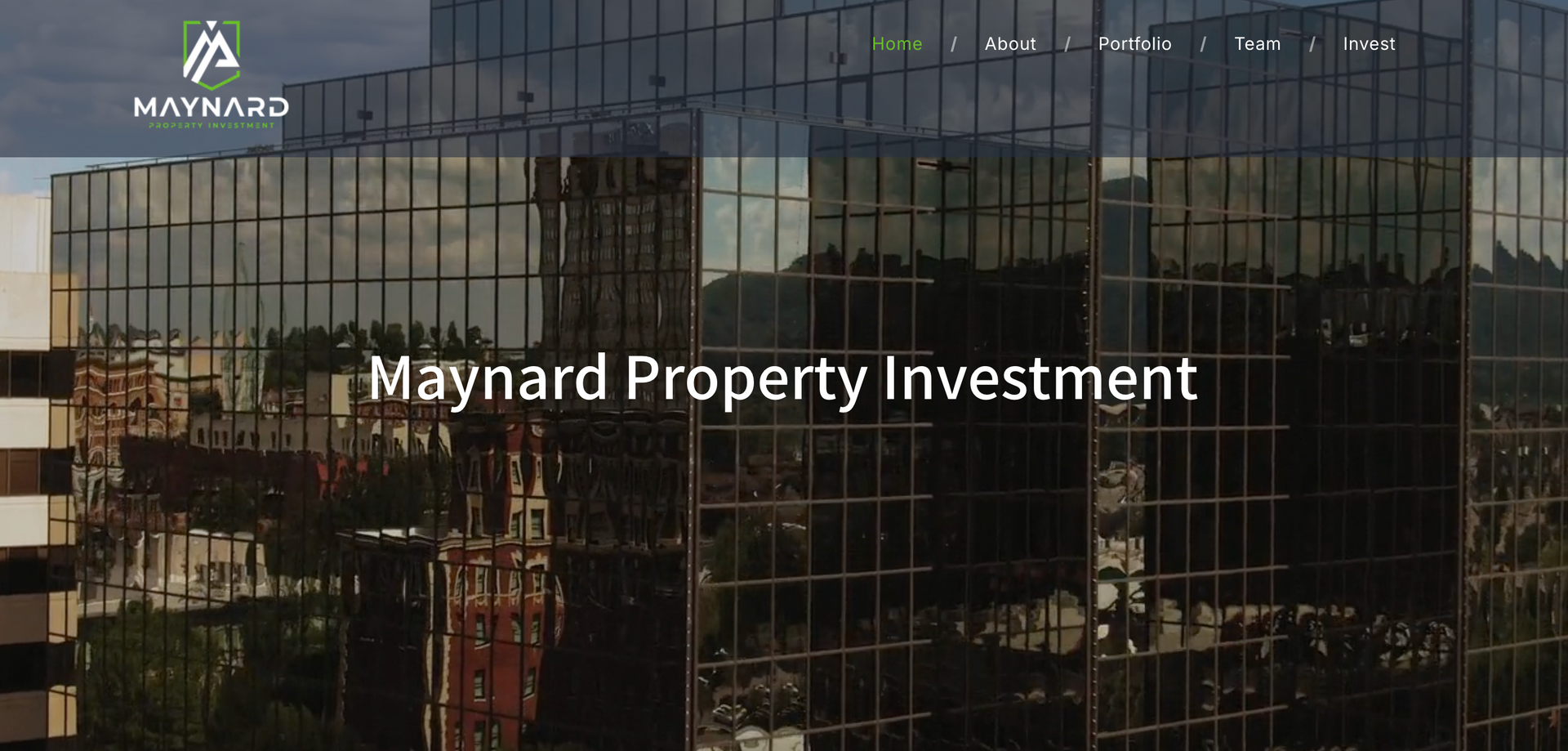 A glass skyscraper reflects the sky and trees, with the text 