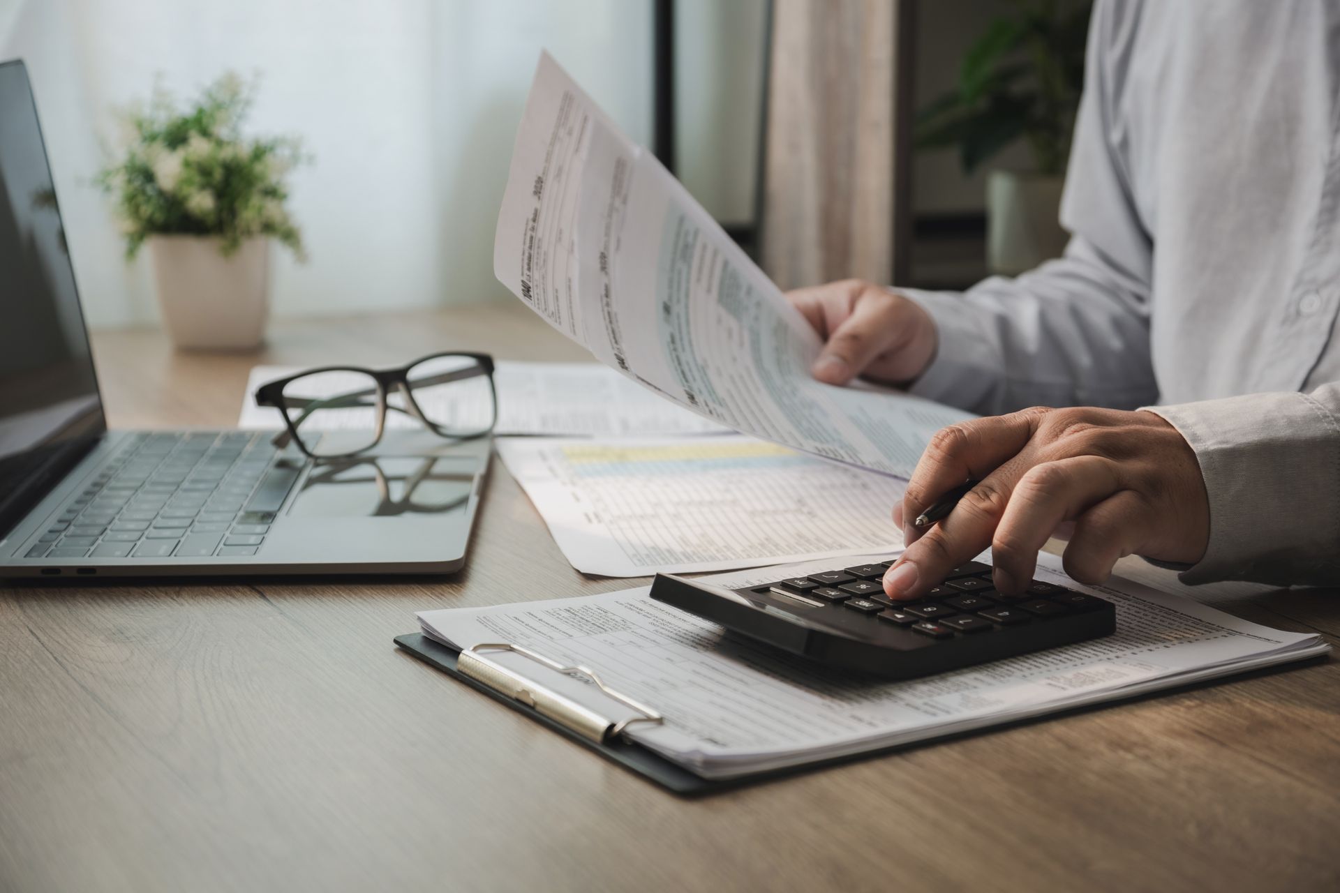 A person is reviewing financial documents.