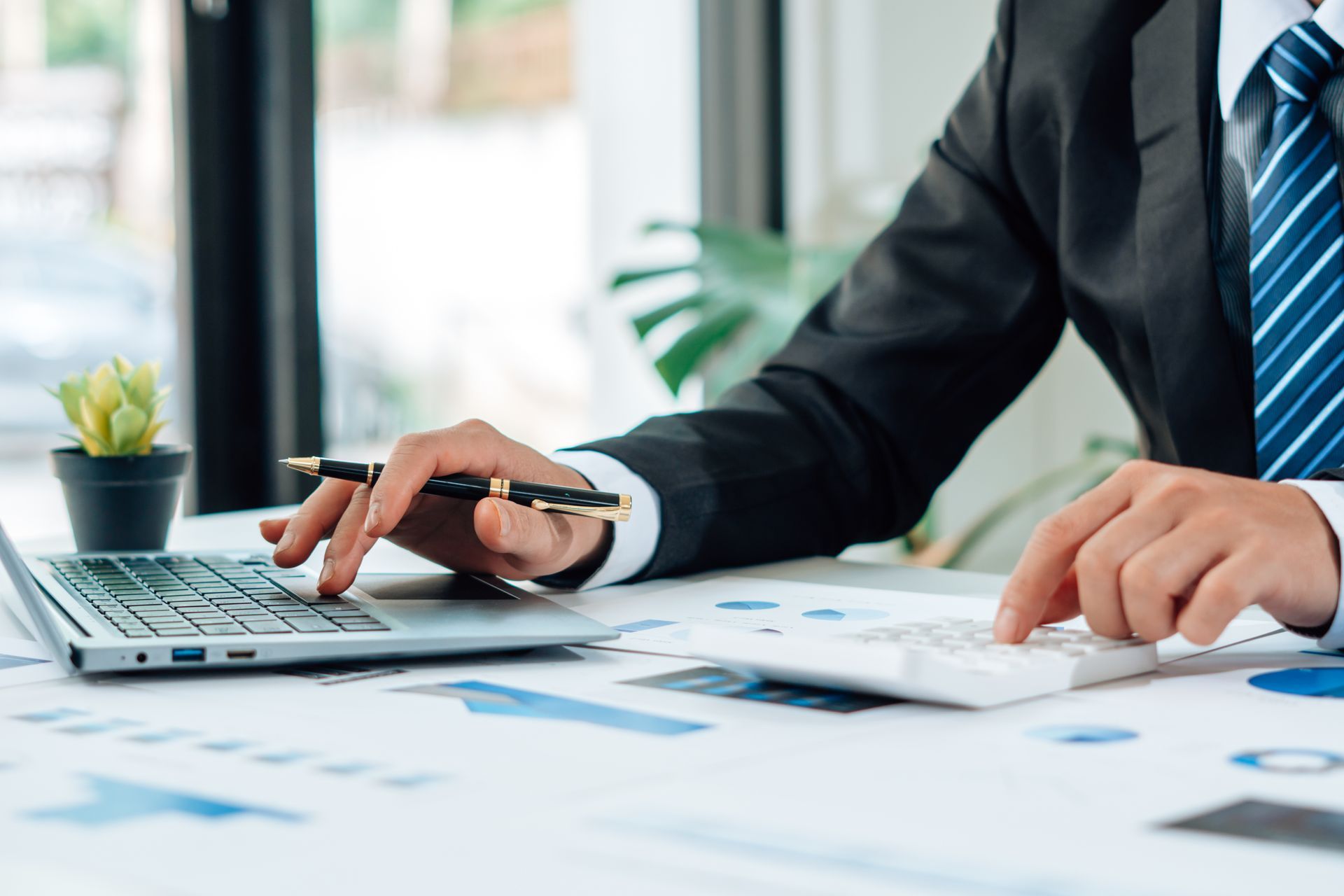 Tax deduction planning concept. Businessman calculating business balance prepare tax reduction. Close-up of a tax accountant calculating annual taxes and finances.