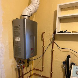 Wall-mounted water heater with white vent pipe and copper plumbing in a utility room.