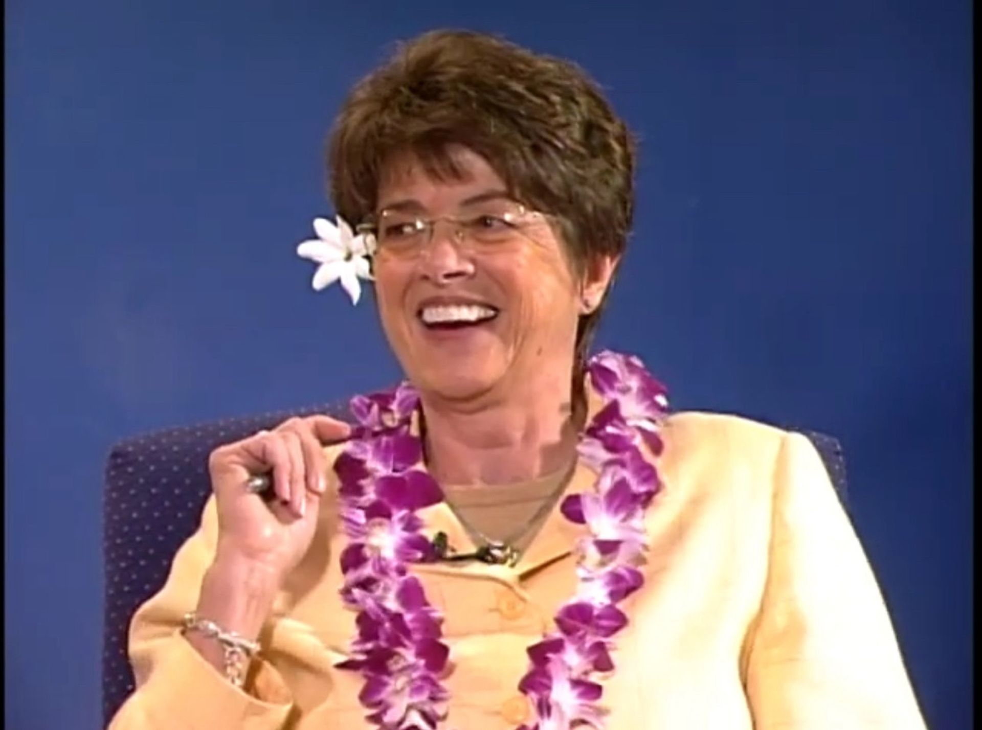 Dr. Barbara Lockhart with a flower in her hair wearing a lei
