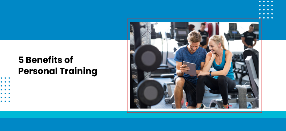 A man and a woman are sitting in a gym looking at a tablet.