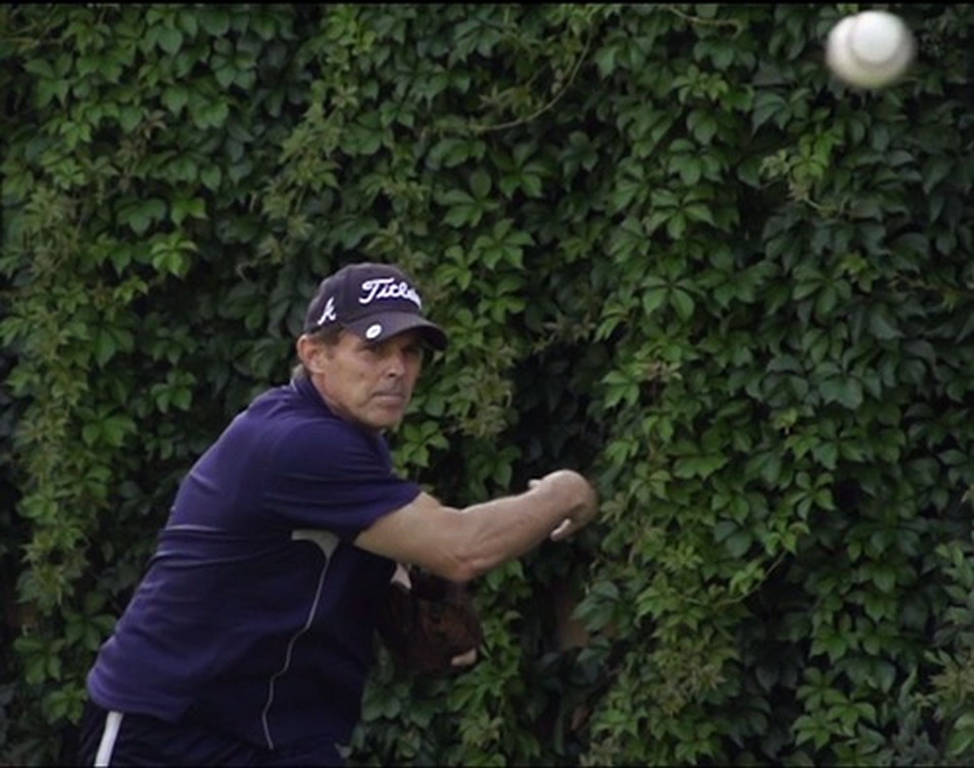 Tom Wright wearing a hat throwing a baseball