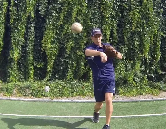 Tom Wright is throwing a baseball on a field