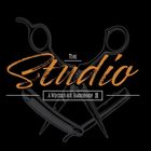 Logo for "The Studio," a barbershop, featuring crossed scissors and a straight razor on a black background.