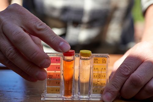 A Person Is Holding A Test Tube With A Red Cap - Oklahoma City, OK - Total Pump & Supply A Person Is Holding A Test Tube With A Red Cap - Oklahoma City, OK - Total Pump & Supply