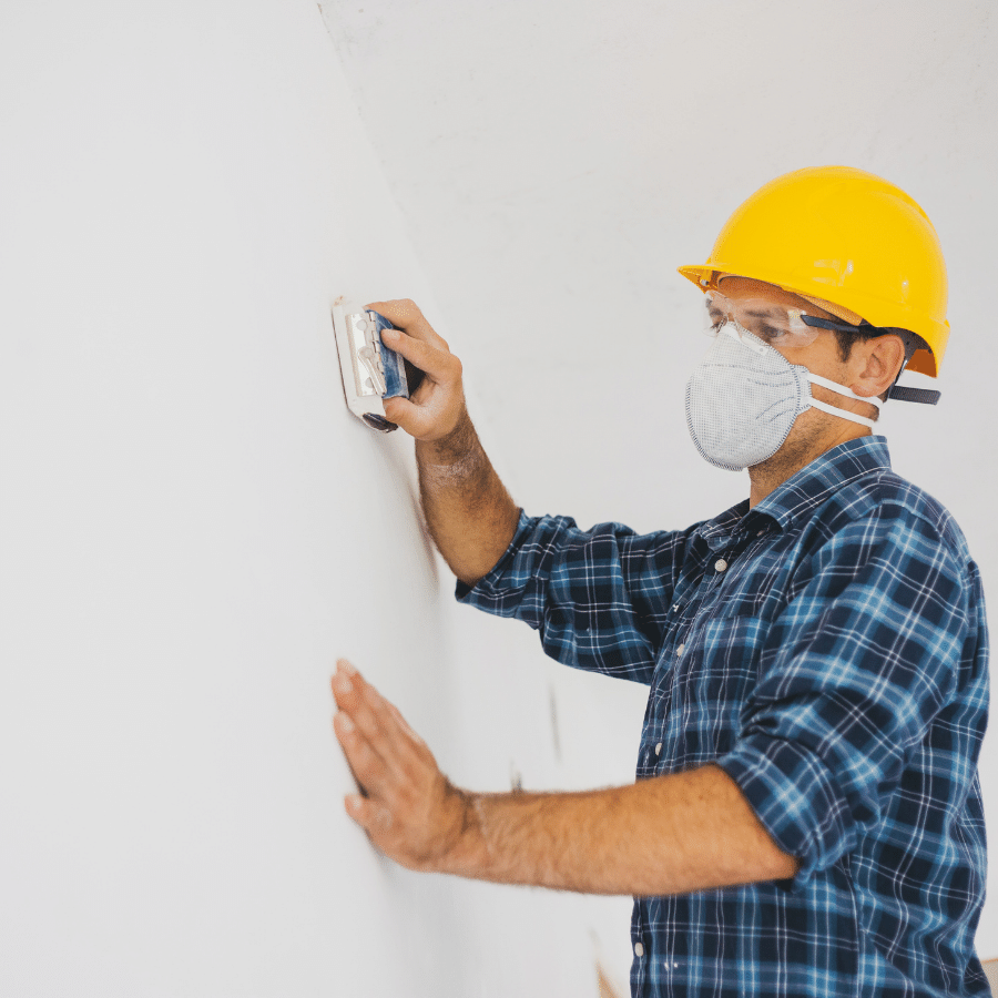 Sanding newly installed wall