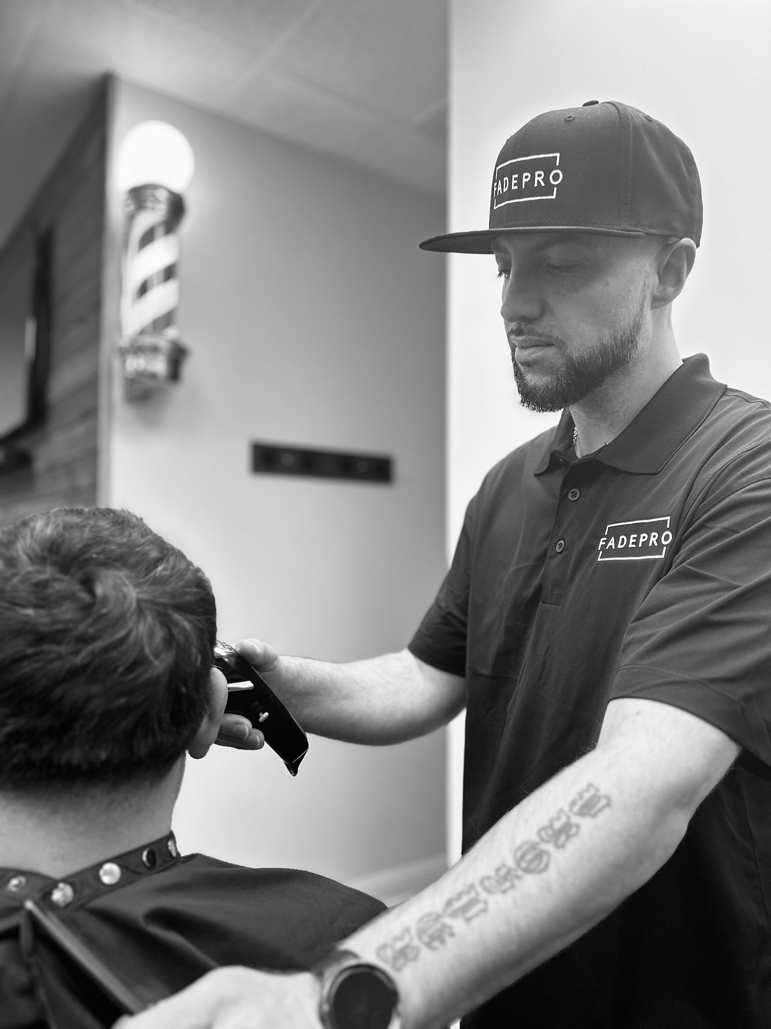 A woman is cutting a man 's hair in a barber shop.