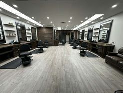 It is a barber shop with a lot of chairs and mirrors.