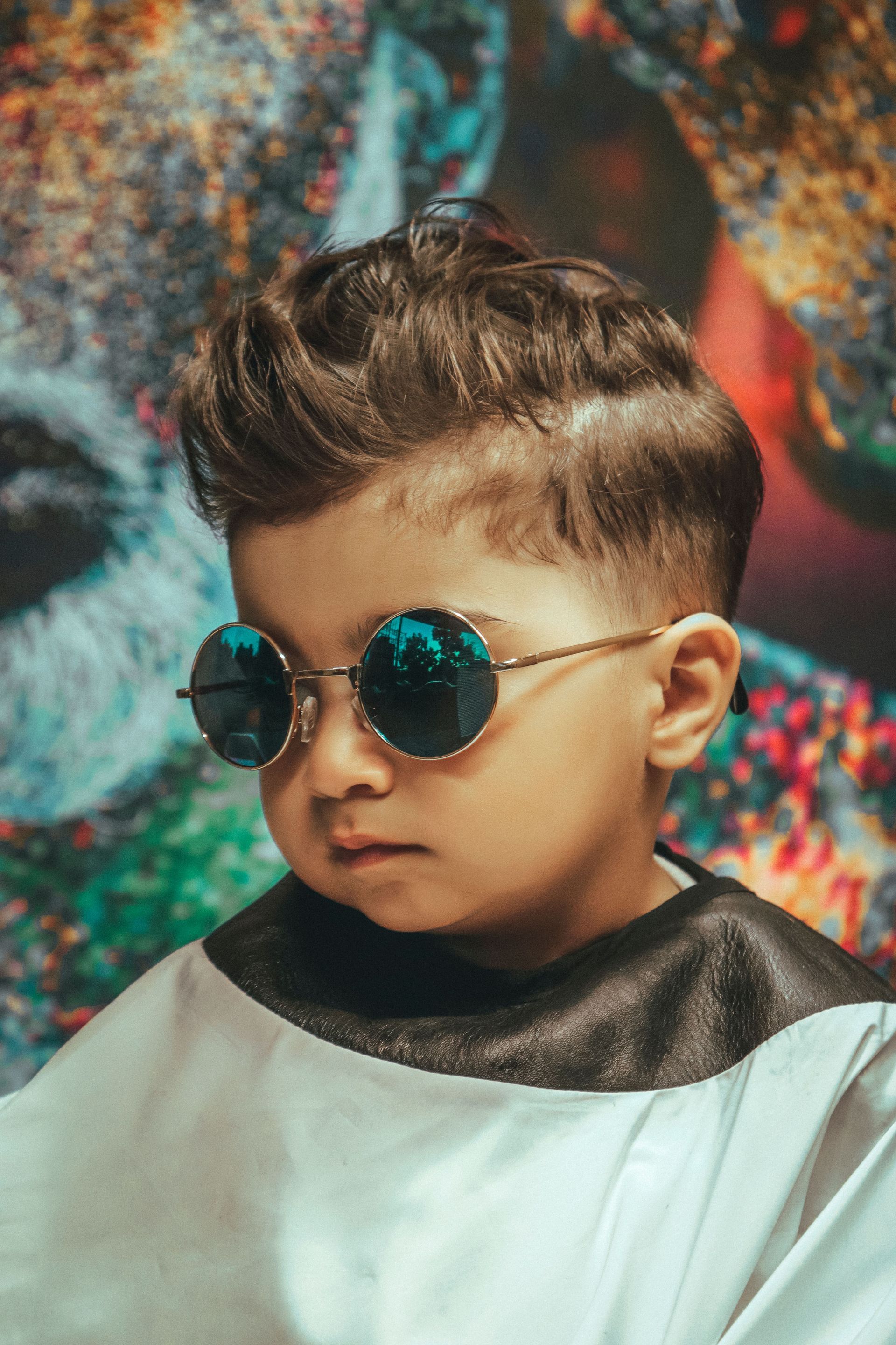A man with a beard is getting his hair cut at a barber shop